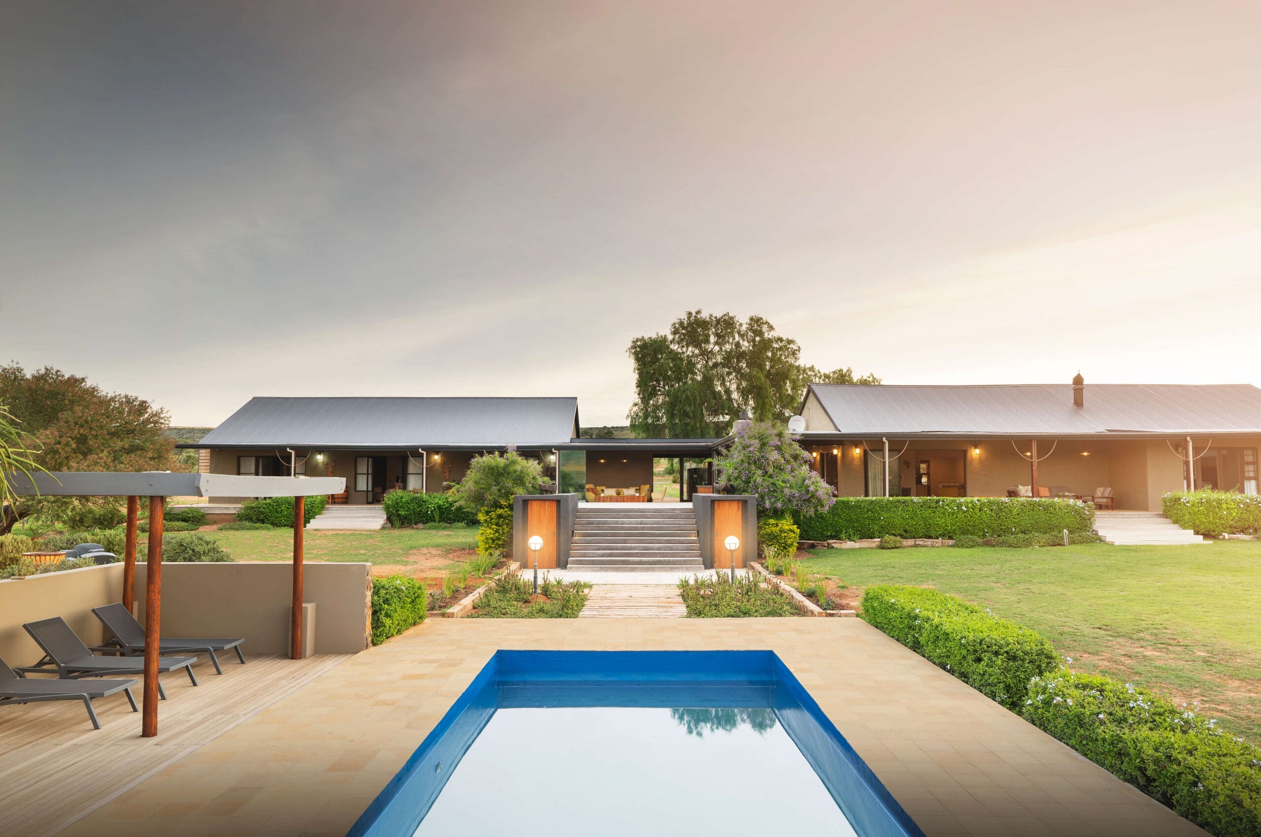 Poolside view of the Ubuninzi Hunting Safaris lodge with the surrounding landscape.
