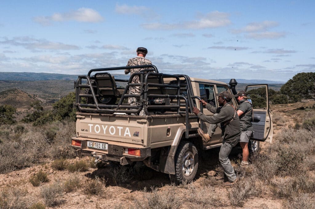 Guests on a safari attentively searching for wildlife.