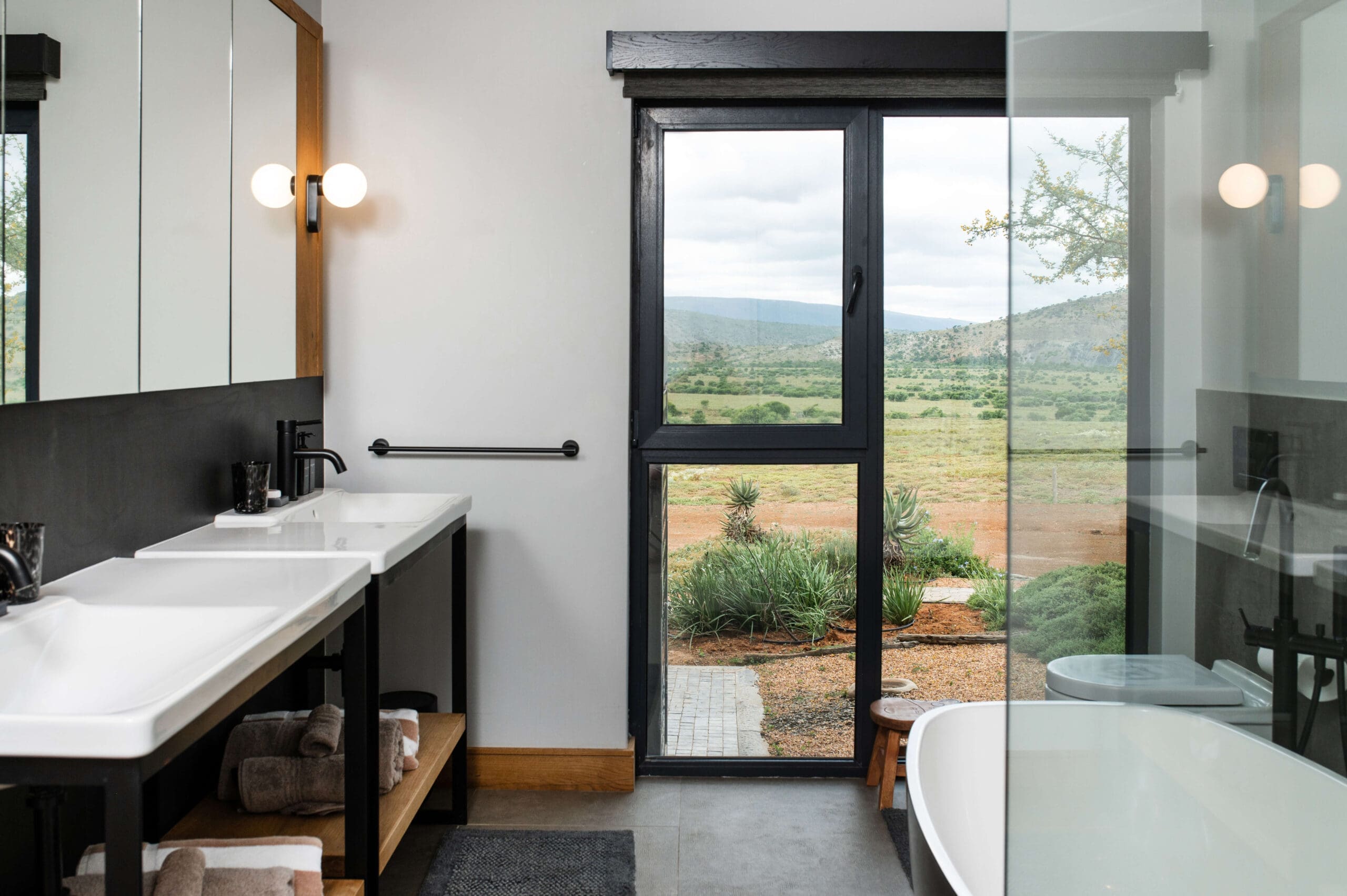 Luxurious bathroom with a breathtaking view of the natural landscape.