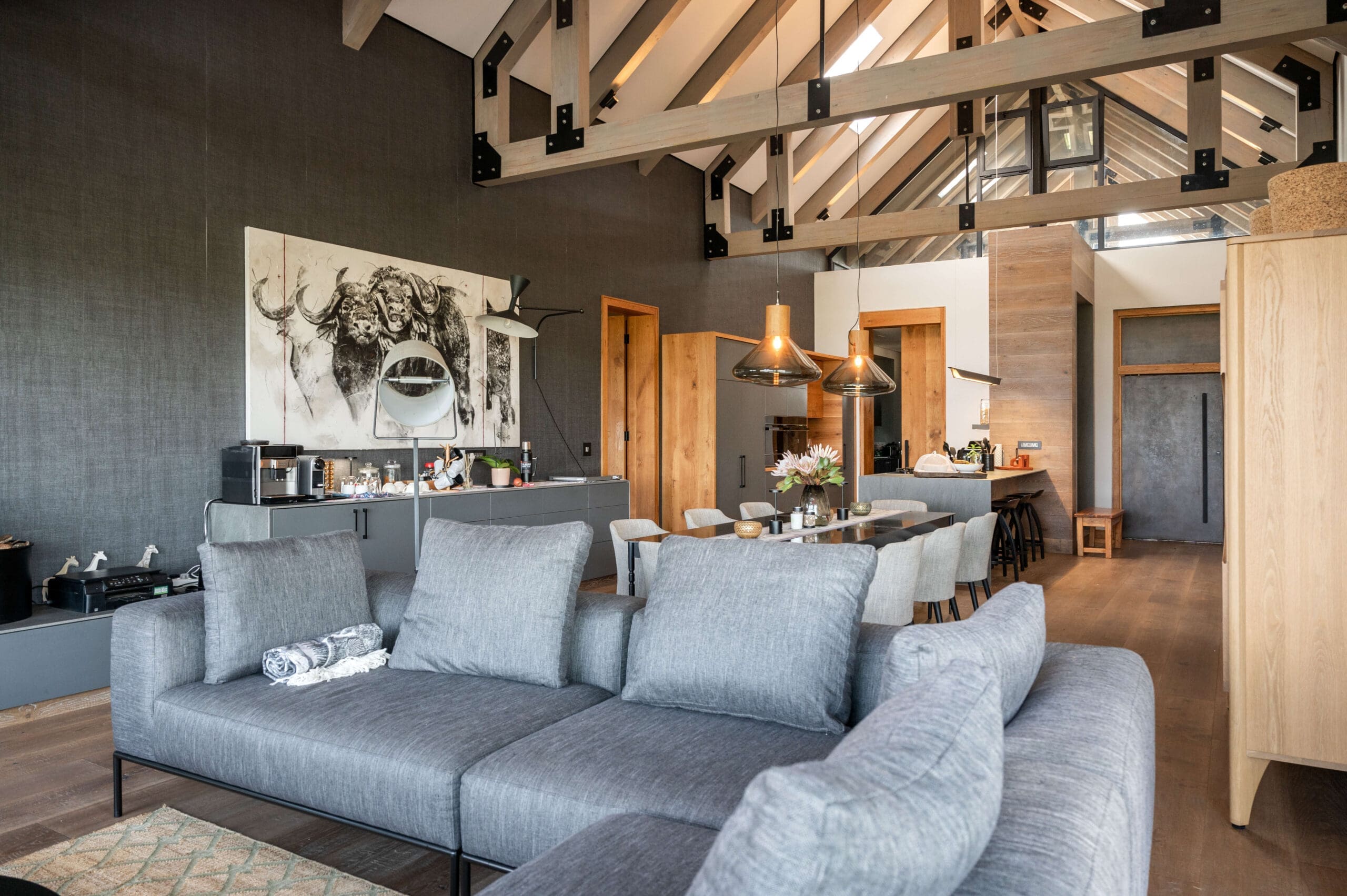 Modern open floor plan featuring a connected kitchen, dining room, and lounge.