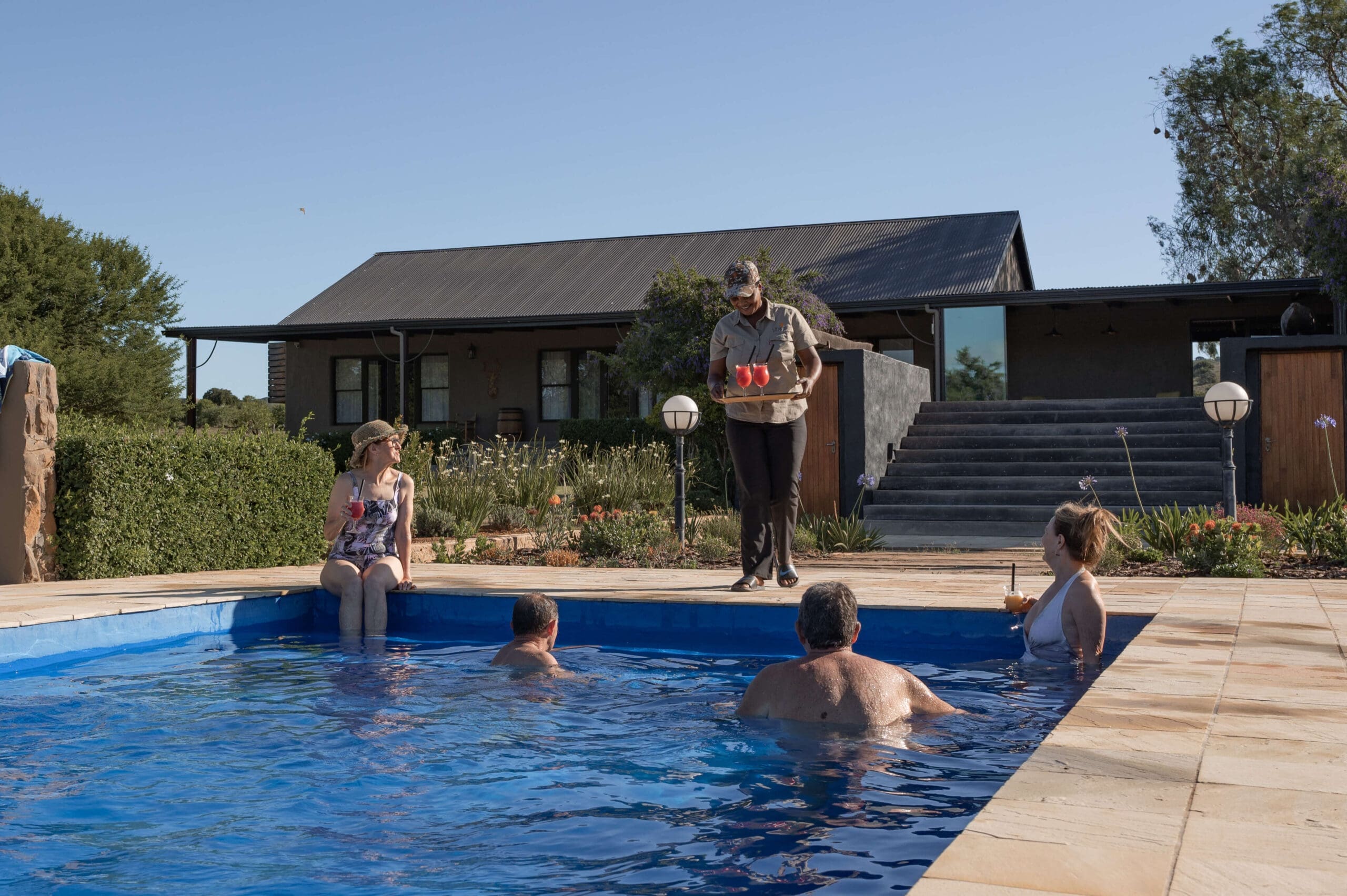Guests enjoying a refreshing swim in the pool at Ubuninzi Hunting Safaris.